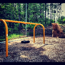 Bethesda tot lot has a nice tire swing, climbing struce and a few otherfeatures such as musical instruments (not pictured) 