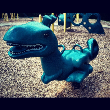 T- Rex playground rocker at Campus Hills