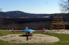 This photo shows the playground of the now-closed Pine Island Elementary School with a black dirt farm in the background.