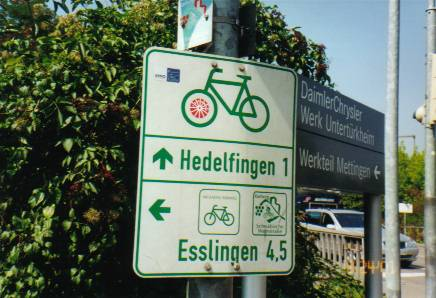 Signs on the bike path to direct cyclists to businesses in uptown.